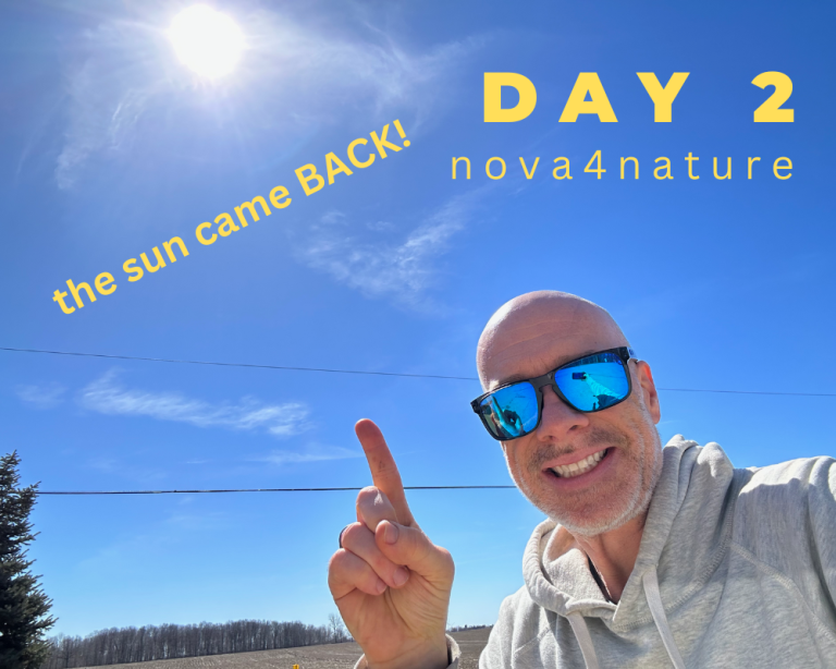 Hub member smiling and pointing to the sun