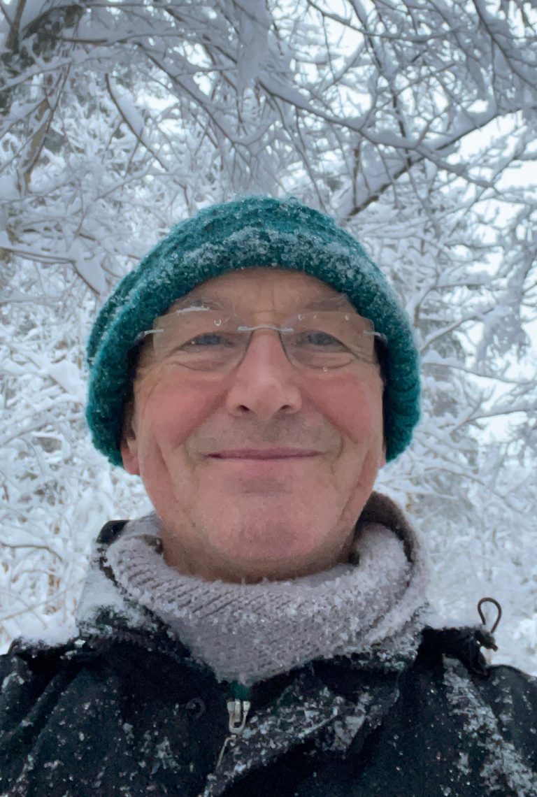 Hartmut wearing a blue hat and glasses in the snow