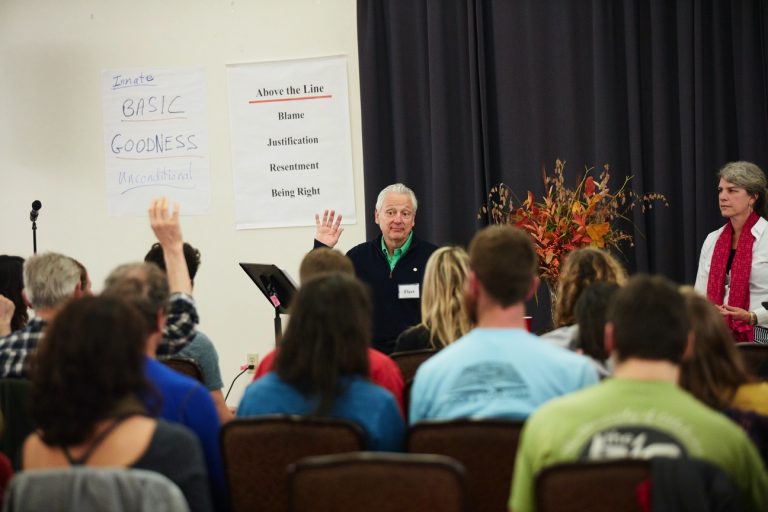 Fleet Maull presenting to a group with key words on a board
